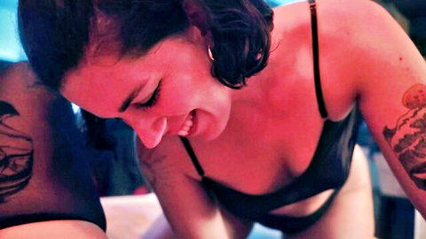 SavannahTheGoddess smiling with tattoos in black lingerie cleavage