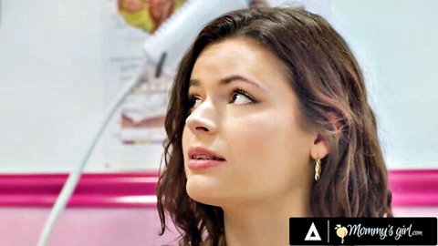 Seductive brunette MILF with long wavy hair and hoop earrings gazes up passionately in Mommy's Girl salon