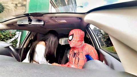 Brunette babe kissing Spider-Man cosplayer passionately in car interior