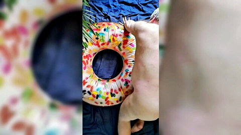 Bluboosh frolicking nude with big body on colorful donut float