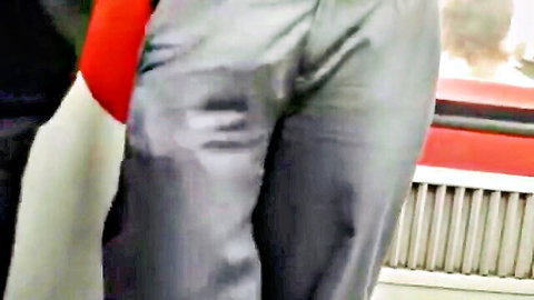 Hot stud in shiny silver uniform pants with massive cock bulge on train