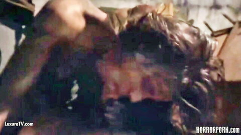 Man brutally yanks woman's long hair from behind in dark bloody horror porn dungeon