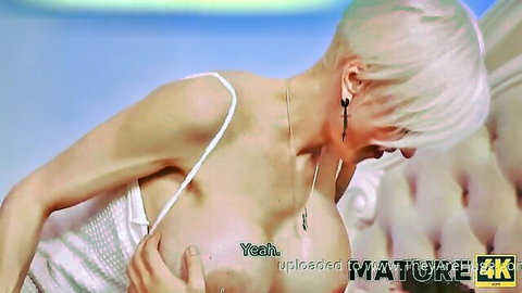 Platinum blonde in white lingerie cupping exposed breast seductively