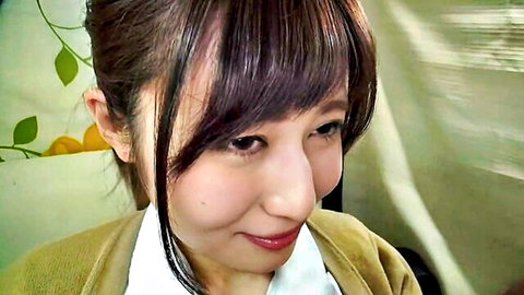 Smiling Japanese woman in cardigan close-up, teasing handjob with panties