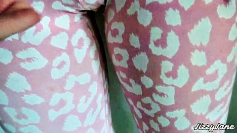 Fitness babe in tight pink leopard print leggings, hand pulling crotch close-up