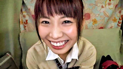 Smiling Japanese schoolgirl in uniform for handjob masturbator play