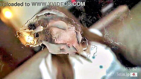Close-up Asian pussy with thick cloudy cum leaking out in fetish scene