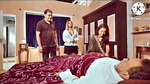 Elderly man in bed with two attractive women attending him