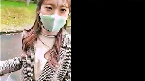 Cute sexy Japanese babe in green mask and checkered blazer outdoors