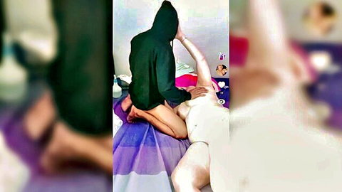 Hooded amateur Asian girl in black hoodie teases diapered partner on bed
