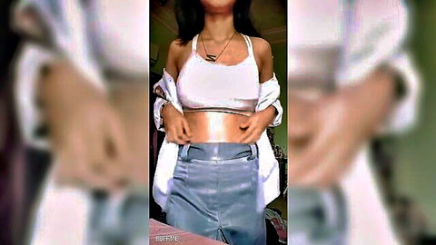 Busty Southeast Asian babe in tight white crop top and shiny shorts teasing her big tits and toned midriff