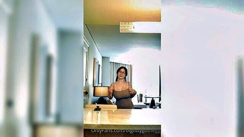 Asian woman in brown dress covering chest for JOI tease