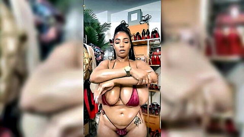 Curvy ebony woman with big tits posing in red bikini