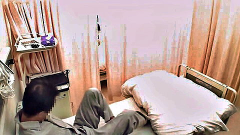Japanese man in hospital bed, pants down in group sex scene
