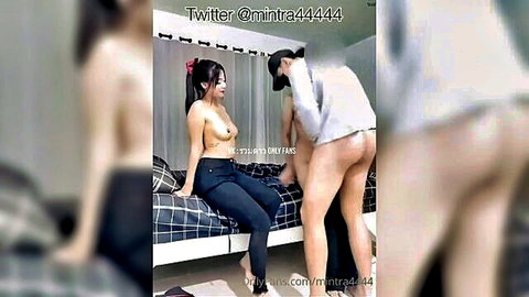 Thai Mintra topless in amateur group sex on bed