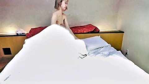 Slim blonde Asian gal with small tits in orgasm on bed