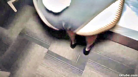 Japanese gravure idol with god-like curves bending over bed in gray dress