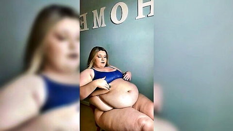 Blonde BBW lounging in blue bikini top showing curves