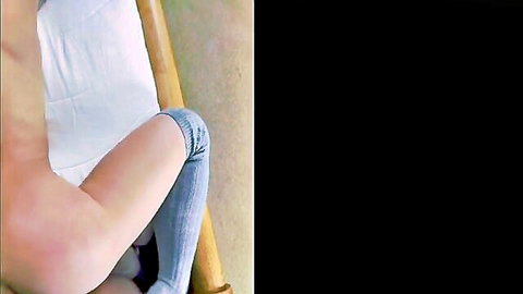 Blonde babe teasing with legs spread wide in tight rolled-up jeans on lounge chair