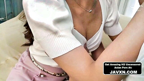Beautiful Japanese teen showing deep cleavage in low-cut white top and pink pants