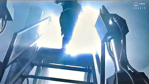Mysterious masked figure in dark attire under intense stage lights