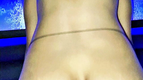 Naked big ass bent over from behind with thin black thong in blue neon lit room