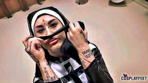 Tattooed nun cosplay babe seductively sucks black pantyhose with glossy lips