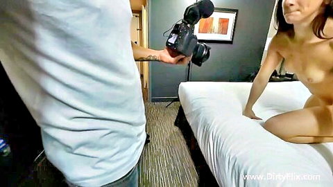 Nude brunette kneeling on bed filmed by cameraman in amateur adult video