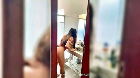 Curvy Latina babe bending over in bathroom, big ass exposed