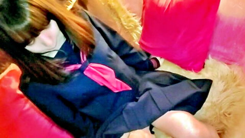 Cute Asian schoolgirl in sailor uniform sitting with legs spread