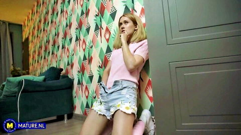 Una Fairy blonde in pink top and daisy denim shorts, seductive bed pose