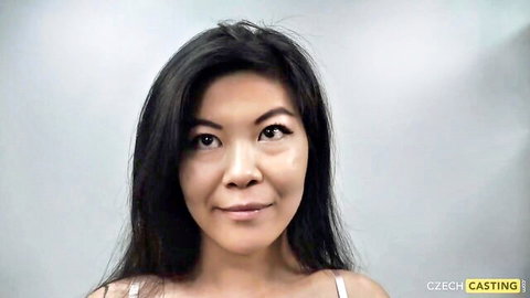 Asian vixen in white tank top smiles in POV casting tease