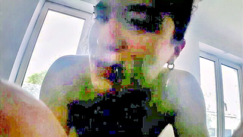 Blurry close-up of short-haired woman in black top performing oral punishment