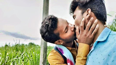 Two Indian men passionately kissing outdoors in jungle, amateur gay embrace