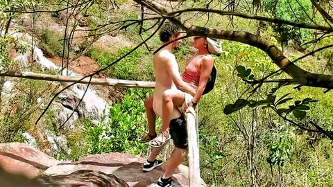 Nude man intimately embraced by hiker in outdoor waterfall setting with oxalisexy
