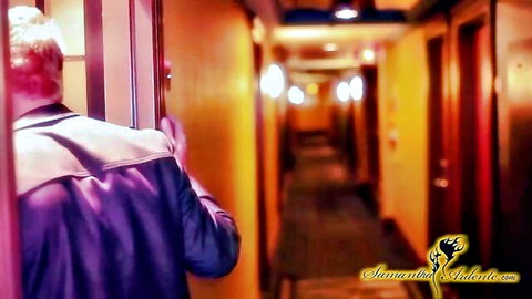 Man in purple jacket enters hotel corridor in MILF threesome teaser