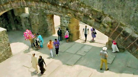 Group in colorful Indian attire at historic stone fort, Daawat e Ishq movie scene