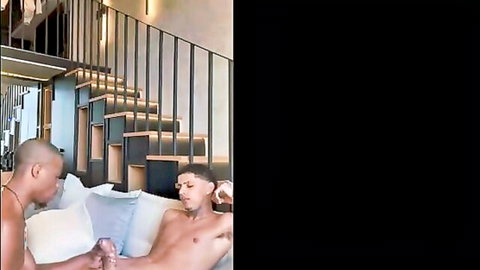 Sexy interracial gay twinks shirtless on couch intimate pose