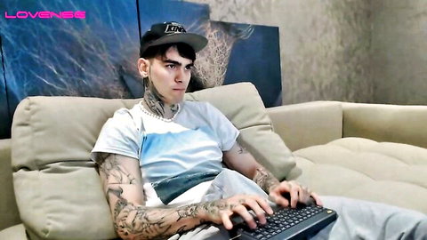 Tattooed young man Fredzo777 in casual tee and sweats on webcam