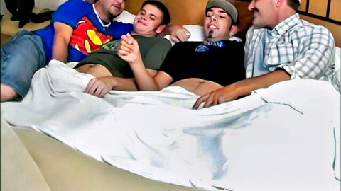 Four shirtless gay hunks cuddling and groping on bed in amateur foreplay