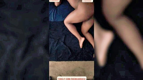 Nude ebony woman spreading legs on bed in solo pose