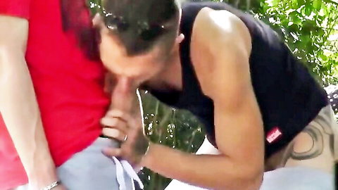 Young guy giving blowjob to muscular man outdoors in amateur gay threesome