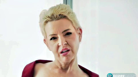 Blonde MILF Bobbi Shay elegant posing in red dress, teasing cleavage