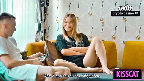 Blonde cutie in tight shorts flirts with guy on yellow couch showing legs
