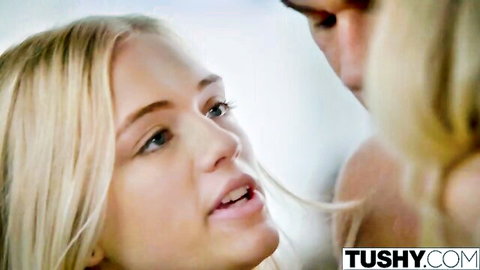 Two blonde babes with blue eyes in intense close-up eye contact