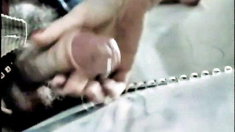 Vintage hand gripping dildo in Dr. Hammer’s Klinik classic XXX scene