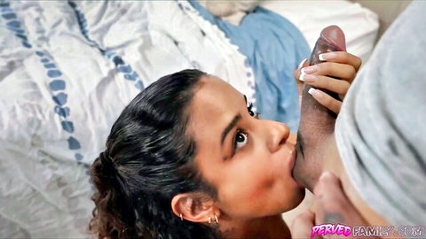 Brunette beauty sucks massive black cock passionately on bed