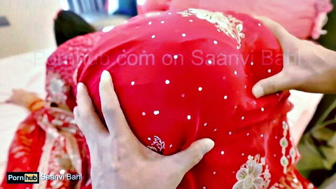 Indian bhabhi in red saree gets her ass cheeks squeezed roughly from behind on bed