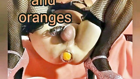 Sissy in fishnet stockings with chastity cage and orange ball for humiliation hypno