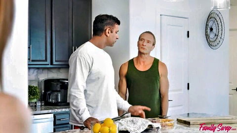 Blonde stepmom watches muscular stepdad and friend in kitchen, hungry for cock tease